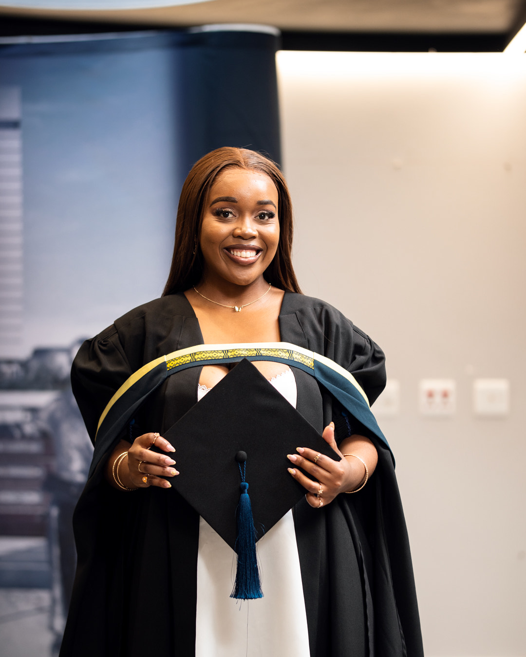 Graduate holding her cap at a graduation ceremony, Port Elizabeth graduation photographer