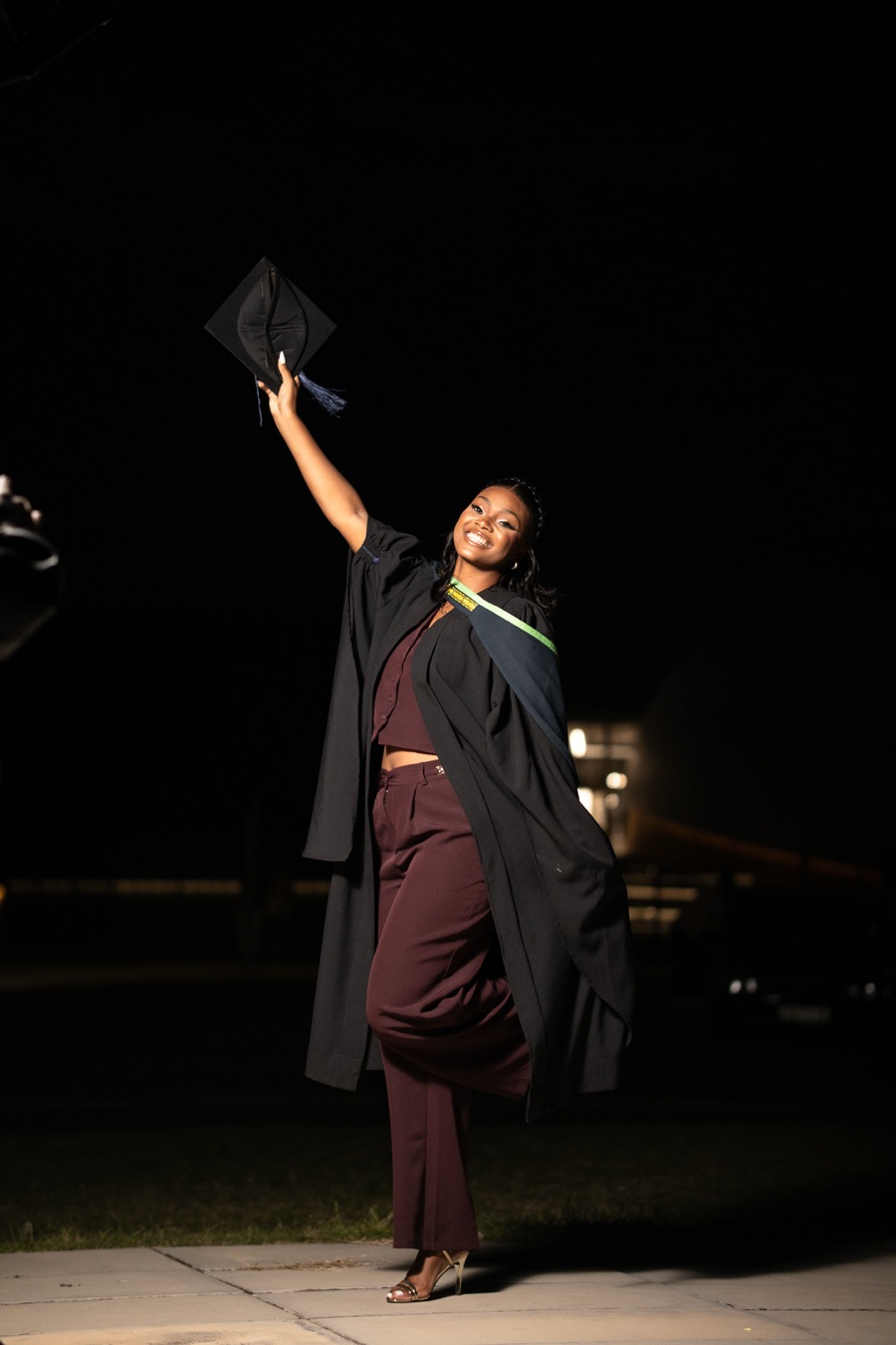 Night graduation photoshoot with cap raised in Gqeberha